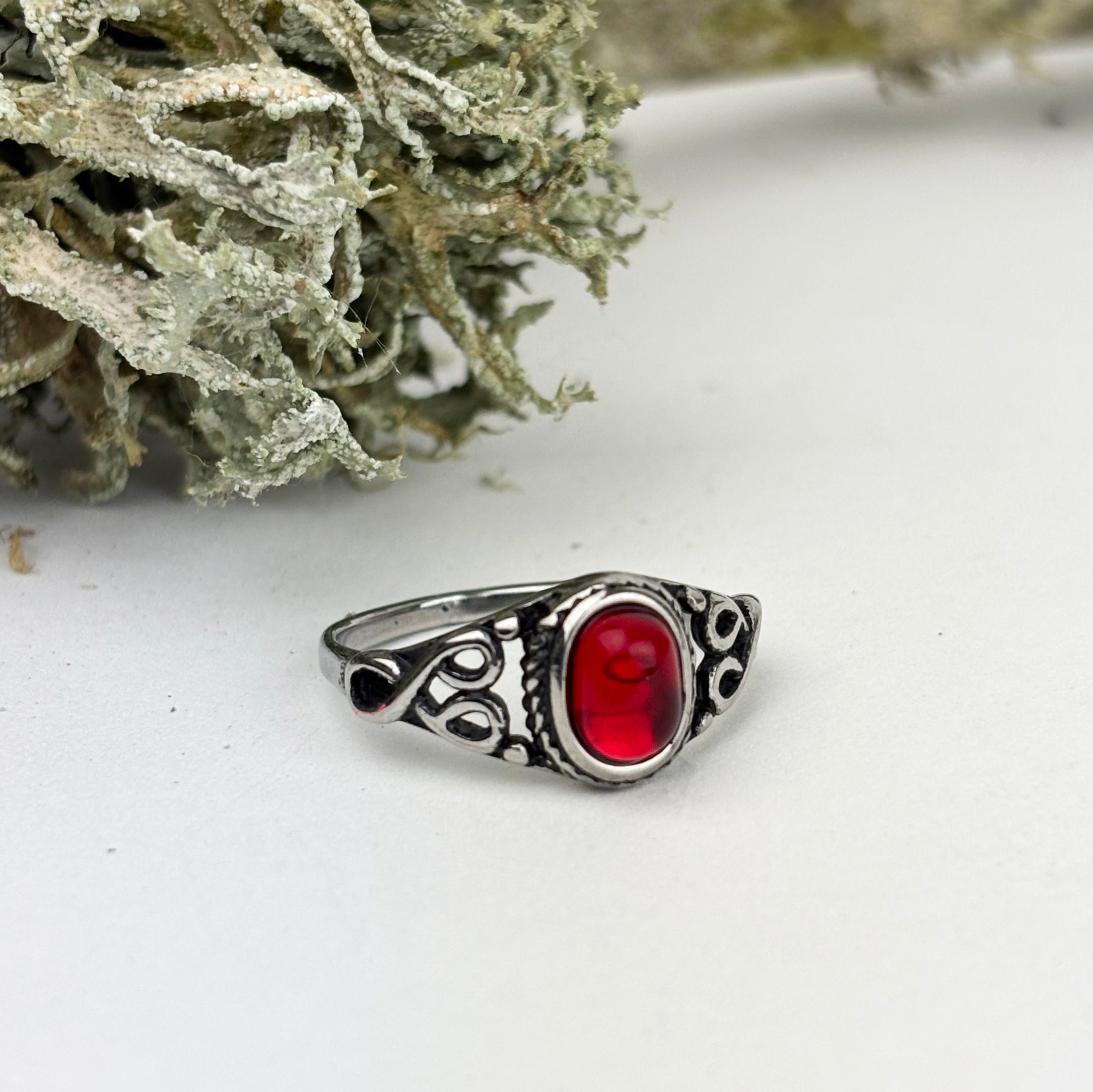 Woman's ring with red oval stone